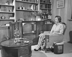 Woman sitting in front of TV